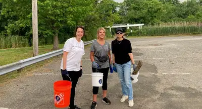 3 people carrying buckets