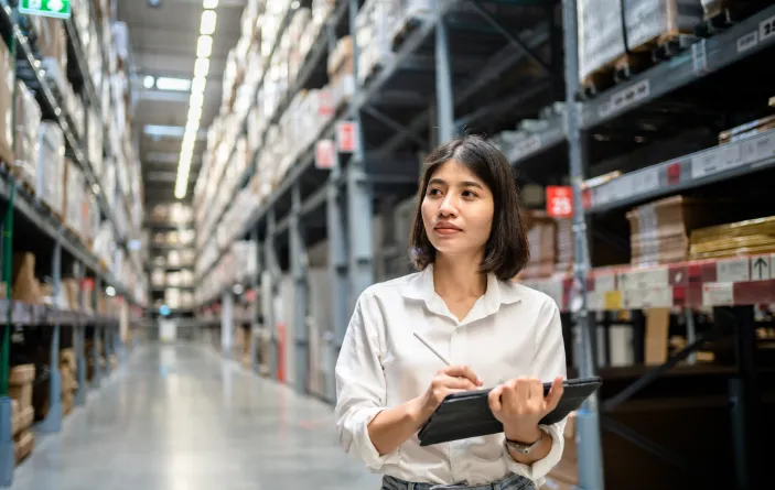 woman in warehouse using tablet